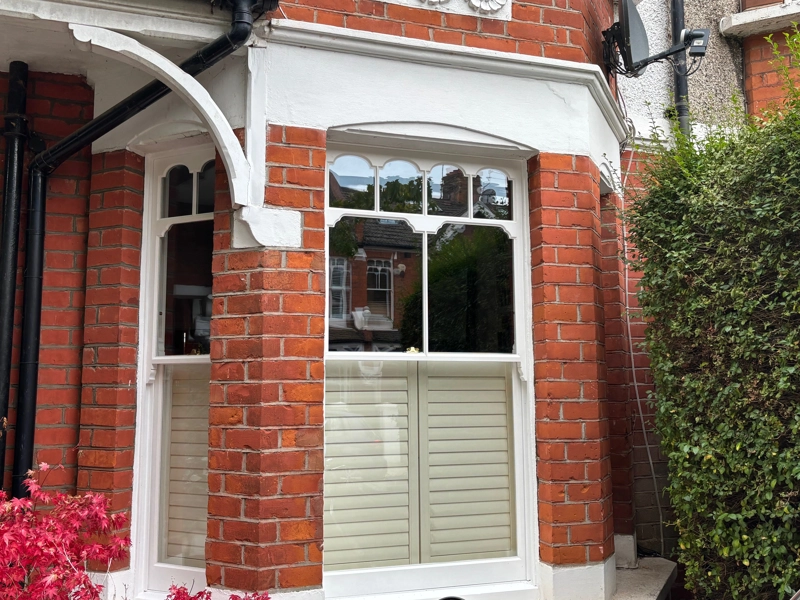 Timber sash window with scalloped pane design